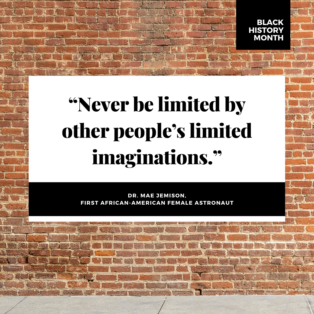 Text on a red brick wall. "Never be limited by other people's limited imaginations." Dr. Mae Jemison, First African-American Female Astronaut